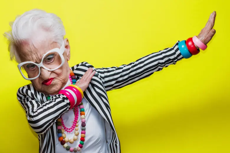 An elderly woman with glasses and a striped shirt, exuding wisdom and style representing name your dance youtube channel 