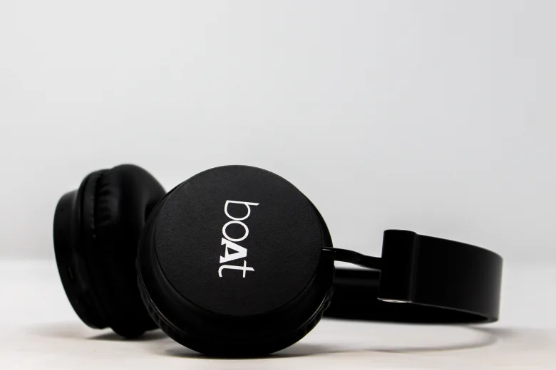 Black Boat headphones lying on a white surface"