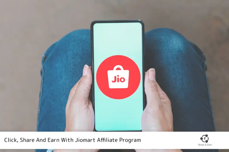 A person holding a mobile phone that Represents Jio Mart Logo