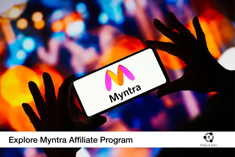 a person holding a phone and its displays myntra logo.